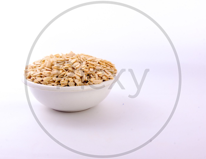 Dry Muskmelon Seeds in a Bowl on an Isolated White Background