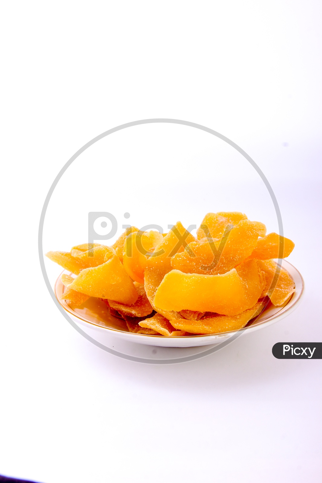 Dried Mango Slices in  a Bowl on an Isolated White Background