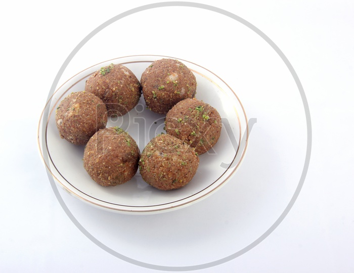 Dry Fruit Laddu in a Plate l on a Isolated White Background