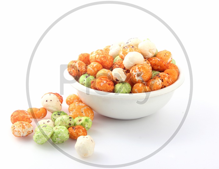 Coloured Fox Nuts / Gorgon Nuts /Makhana / Lotus Seed Pops in a Bowl on an Isolated White Background