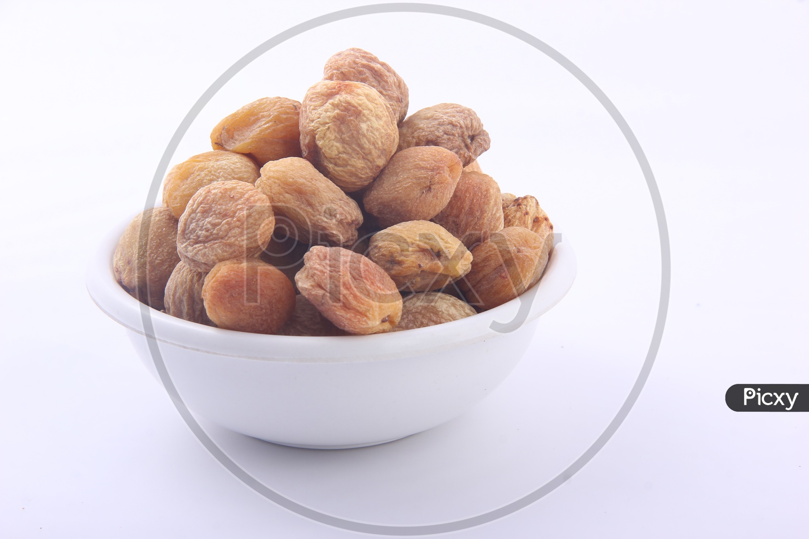 Organically Dried Apricots in a Bowl  Isolated on a White Background
