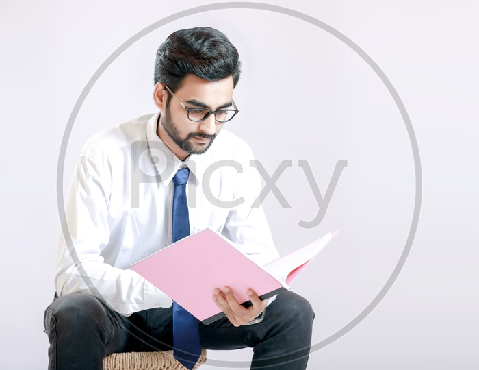 Young handsome man  referring documents with White background / Young Man Portrait