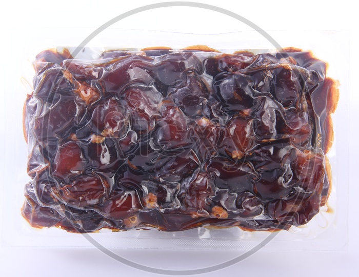 Dates Packed in a Tight Polyethylene cover  on a White Background