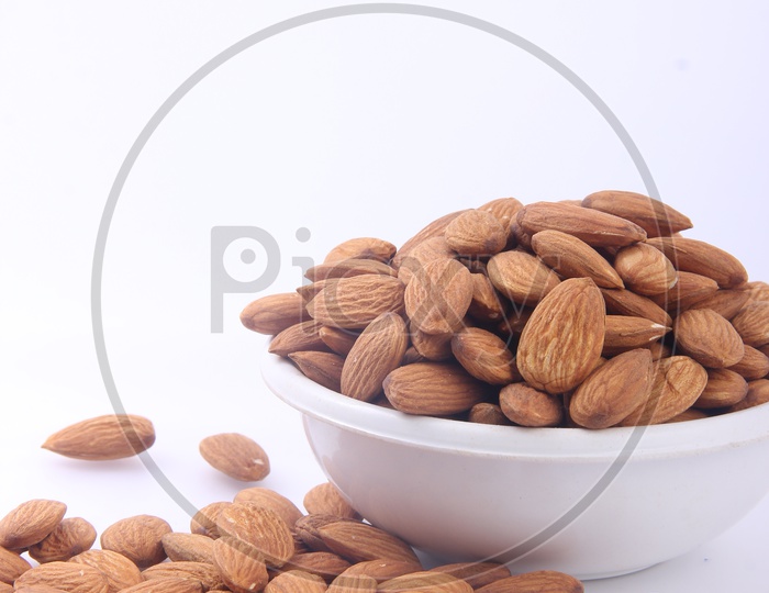 Almonds in Bowl on an Isolated white Background