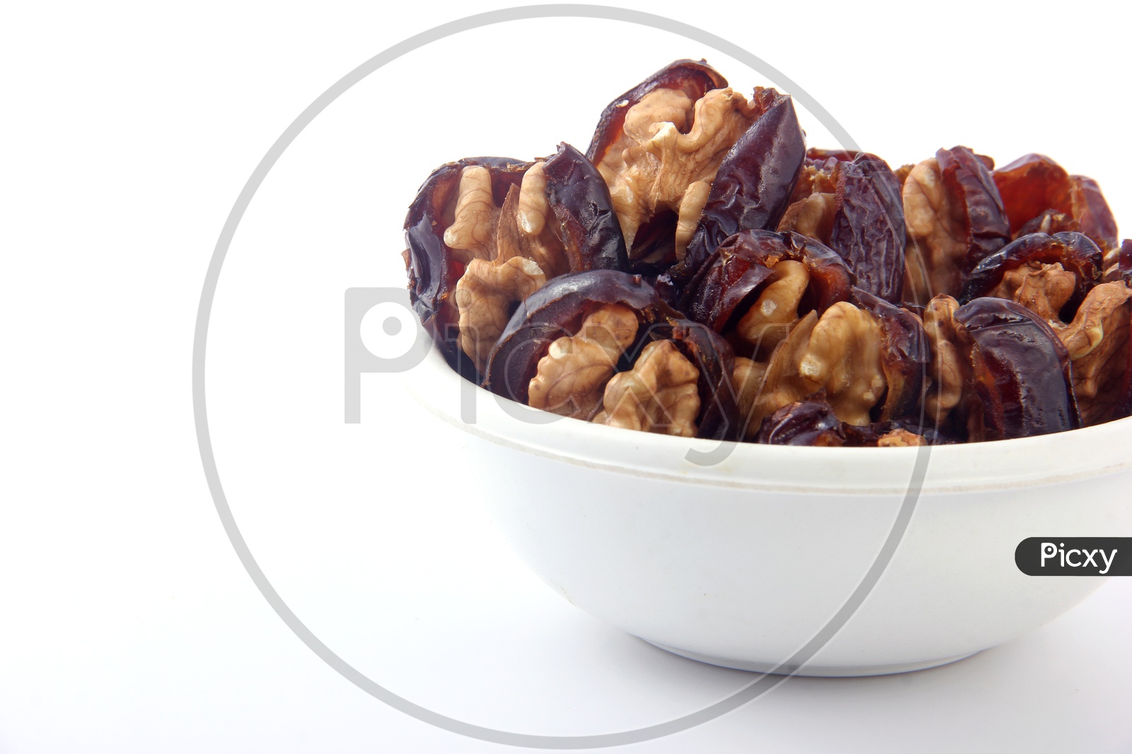 Walnut-Stuffed Dates in Bowl Isolated in White Background