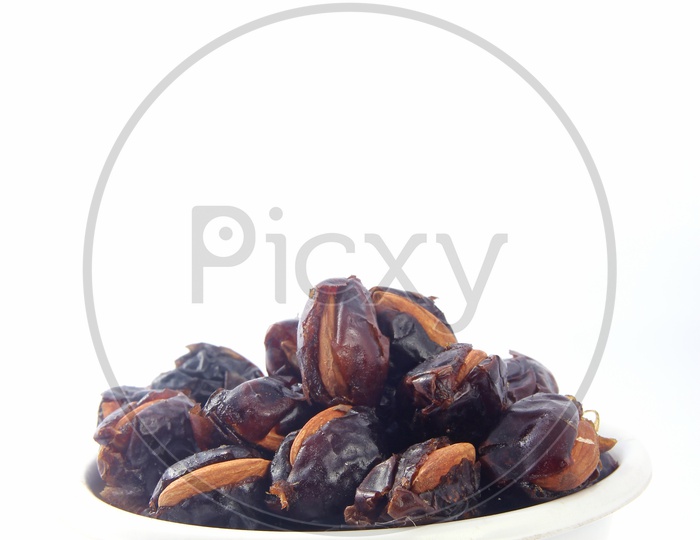 Almond-Stuffed Dates in Bowl Isolated in White Background