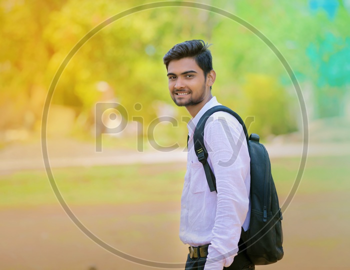 Indian Young man Wearing  Bag Looking Confidently into Camera and Smiling