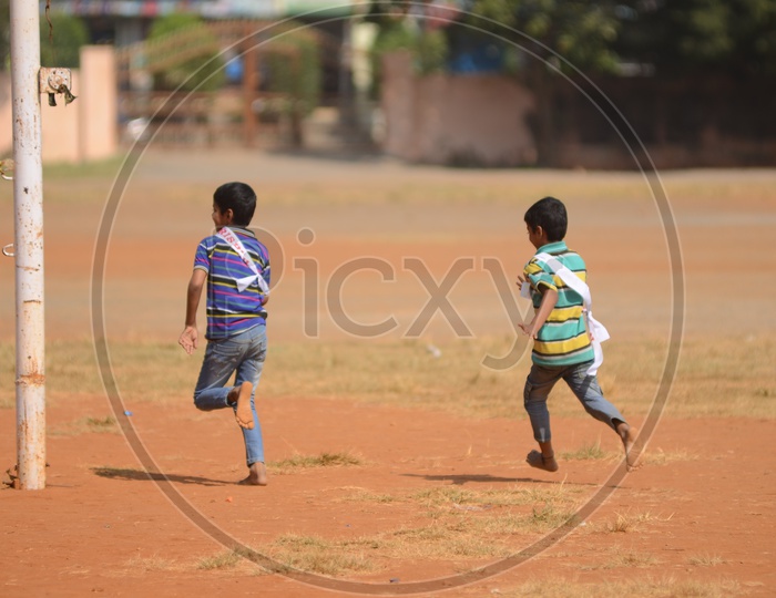Boys run on a play ground