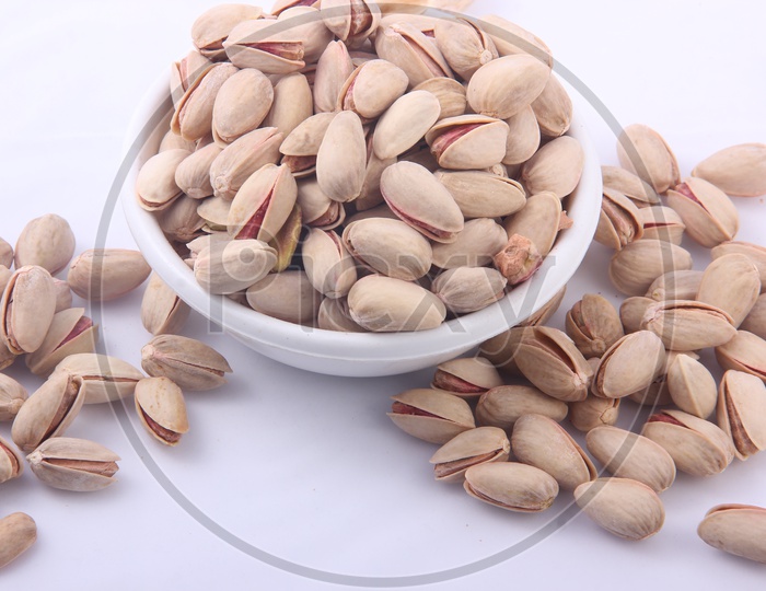 Pistachios in Bowl on a Isolated white Background