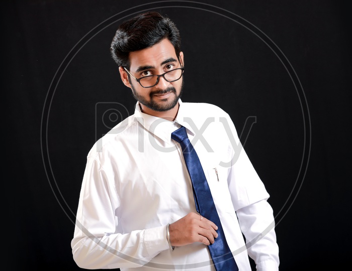 Portrait Of A Confident Young man in Formal wear looking to Camera With Black Background