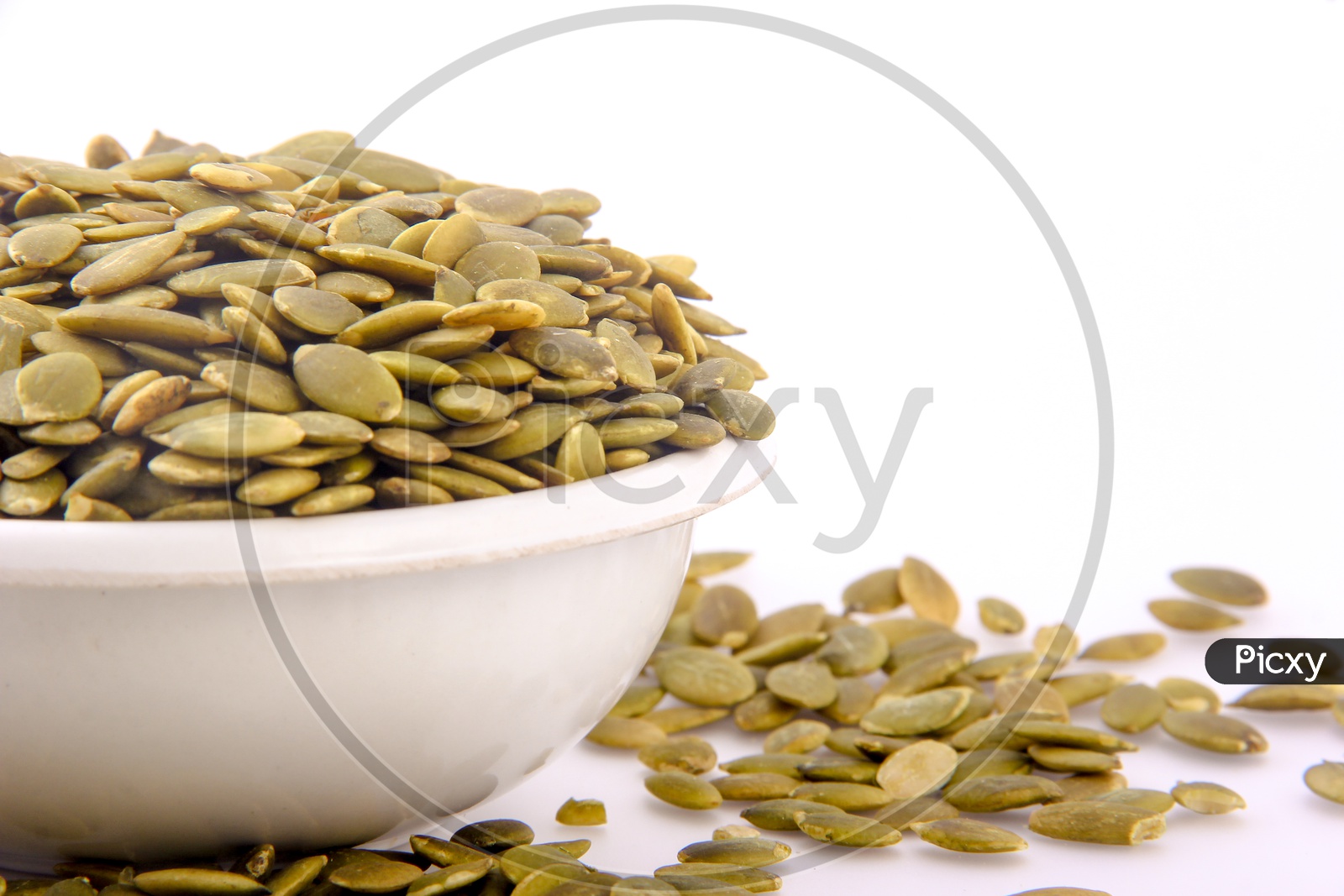 Pumkin Seeds in a Bowl On an Isolated White background