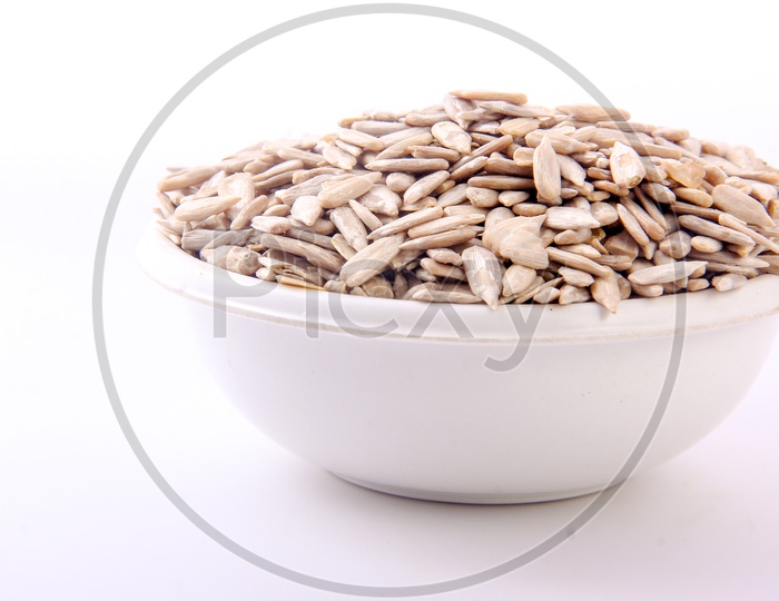 Pumkin Seeds In a Bowl on an Isolated white Background