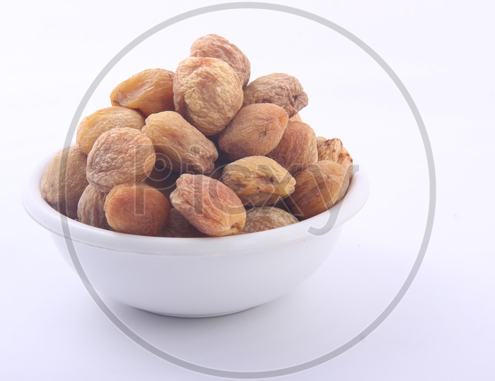 Organically Dried Apricots in a Bowl  Isolated on a White Background