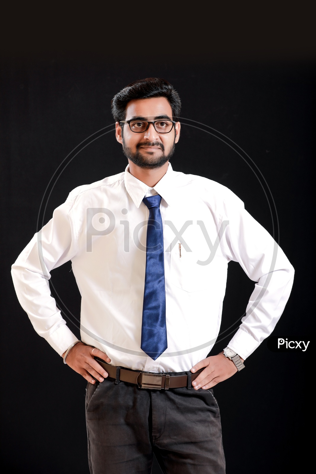 Portrait Of A Confident Young man in Formal wear Showing into Space and  looking to Camera With Black Background