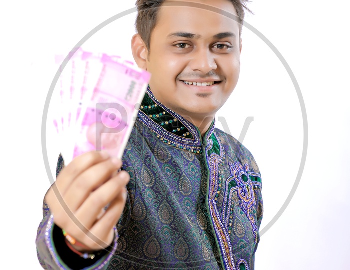 Indian Businessman Holding Money in His Hands On an isolated White background