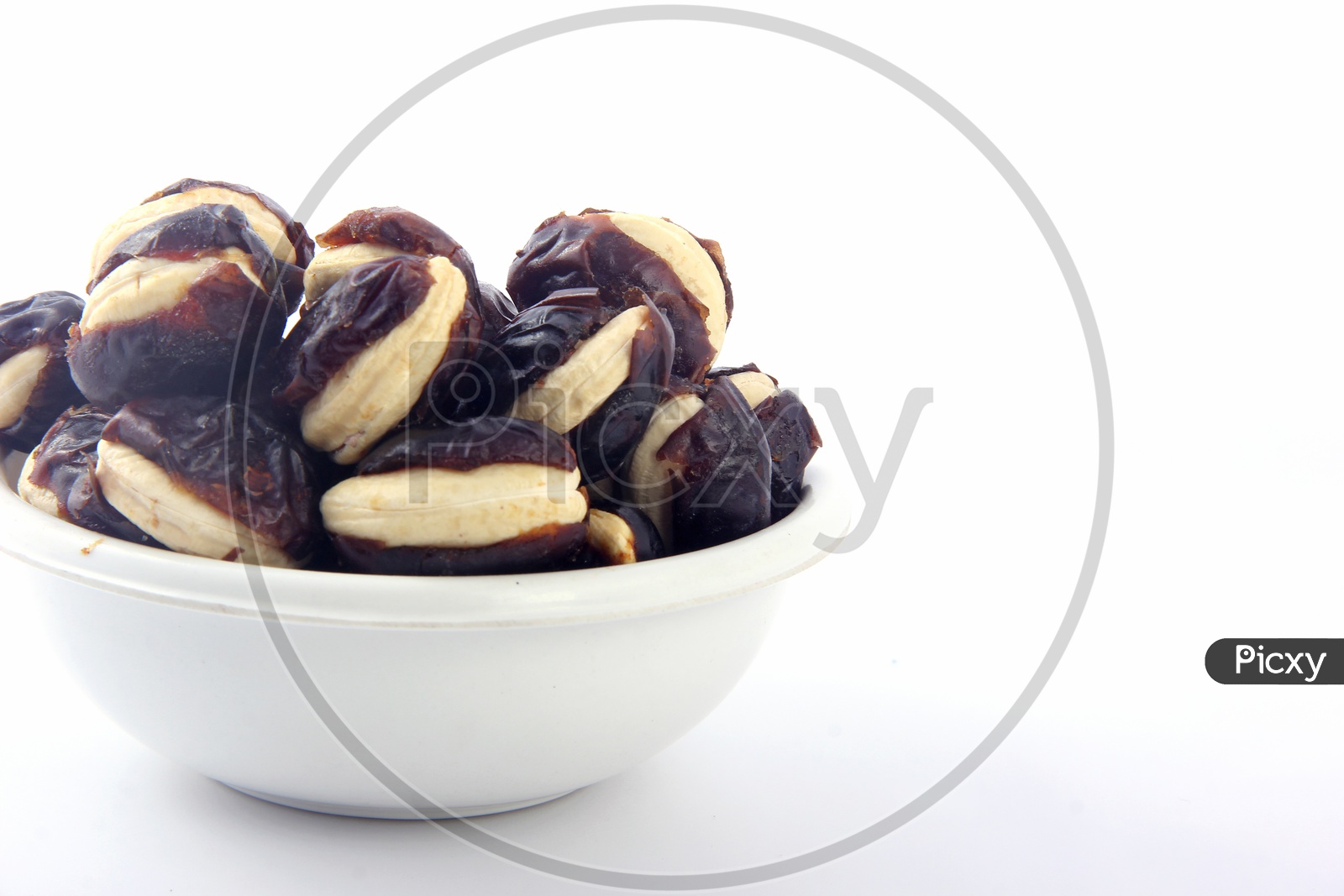 Cashew-Stuffed Dates in Bowl Isolated in White Background