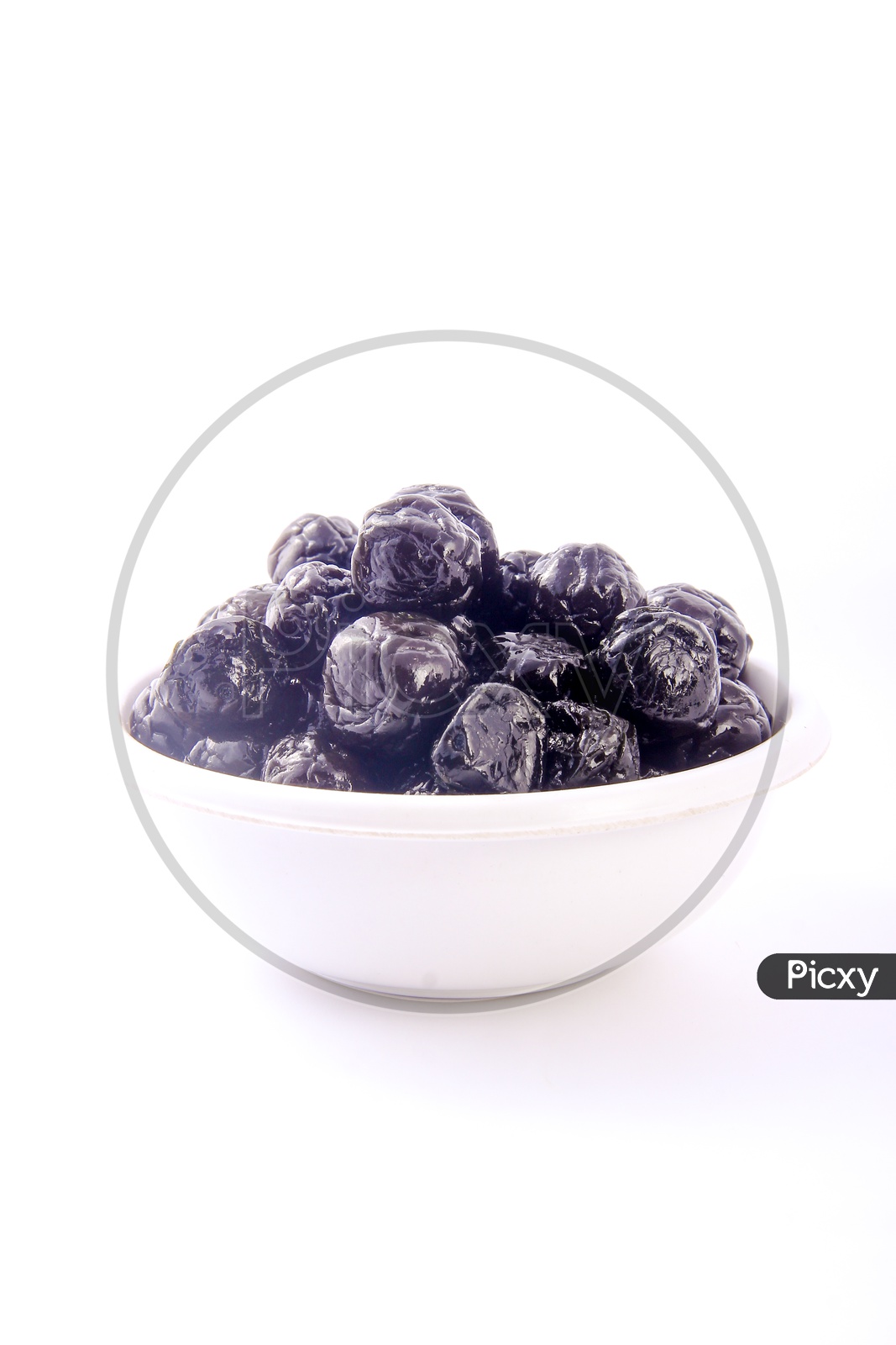 Dry Prunes  / Plums in a Bowl on an Isolated White Background