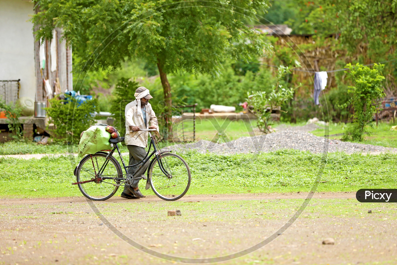 Rural Indian Villages. Farmer taking good on cycle.