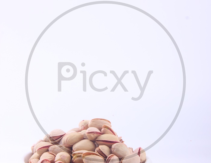 Pistachios in Bowl on a Isolated whitw Background