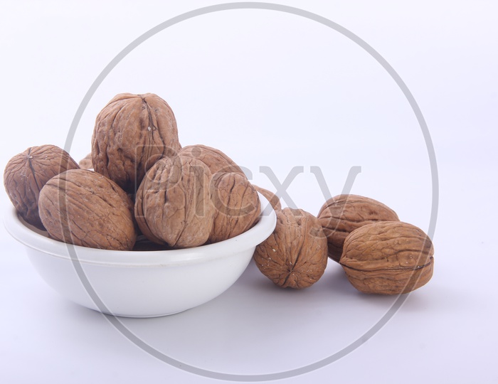 Wallnuts in Bowl  Composition Shot on a Isolated White Background