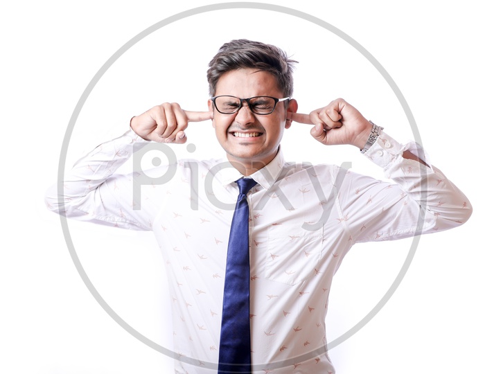 Portrait Of A Confident Youngman in Formalwear  With Expression and Closing His Ears with Fingers   With White  Background