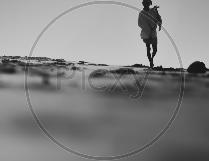An Old Man Walking Alone On Onshore Beach / Man Walking Alone on Bay