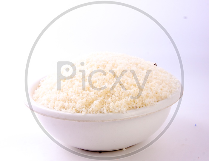 Dried Grated Coconut in a Bowl On an Isolated White Background