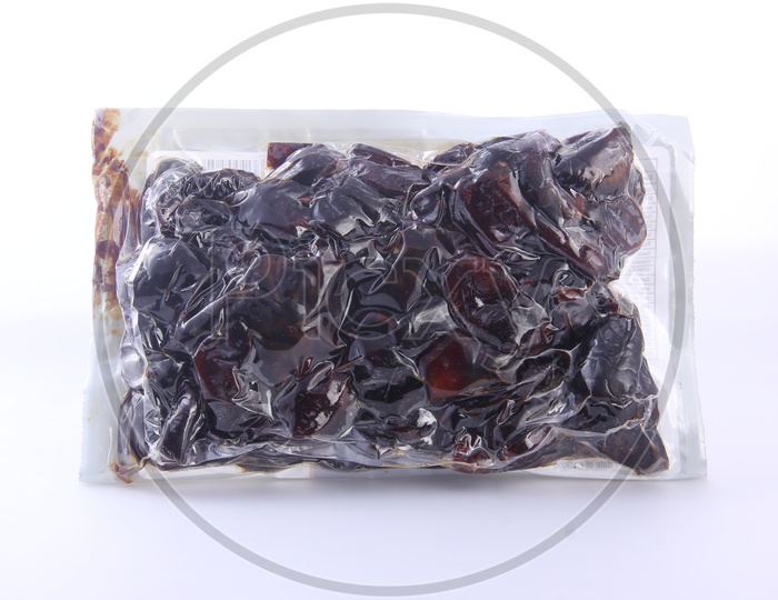 Dates Packed in a Tight Polyethylene cover  on a White Background