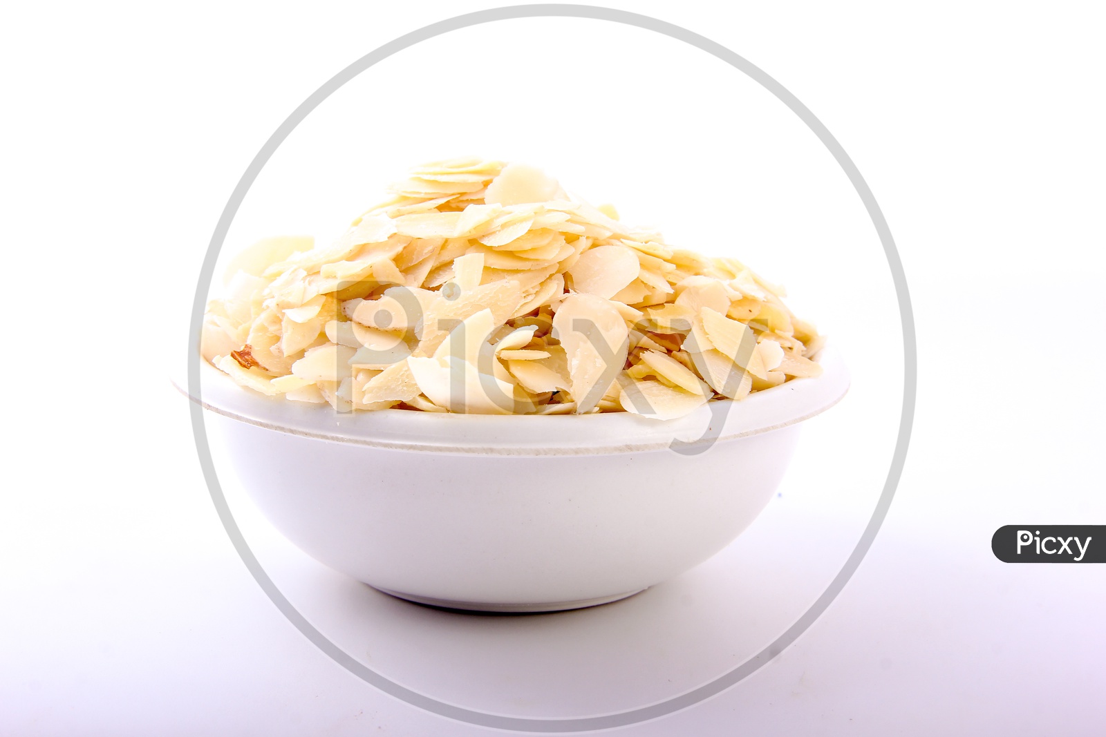 Almond / Badam Flakes in a Bowl On an Isolated White Background