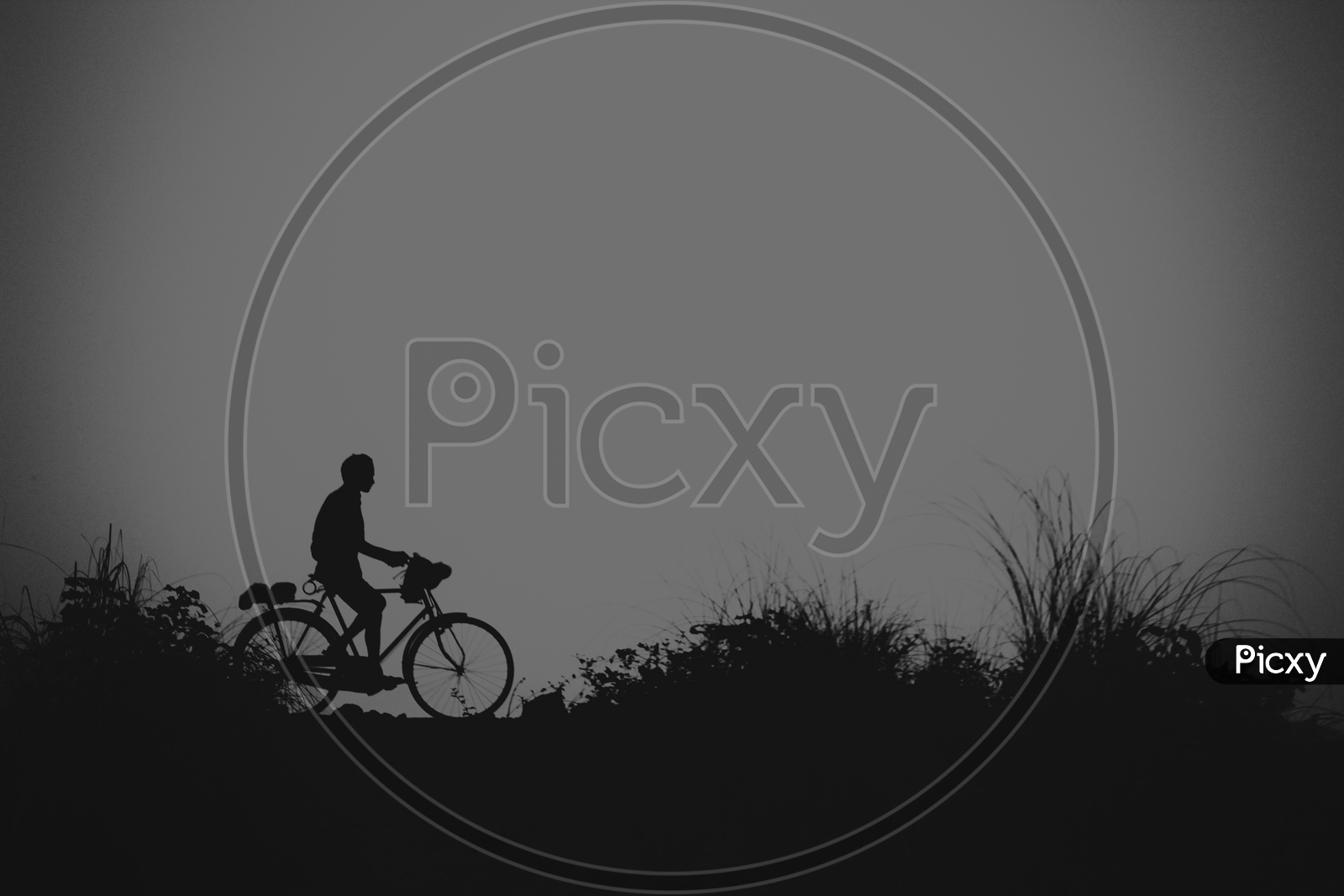 Silhoutte Of A Indian Man Cycling On a Road