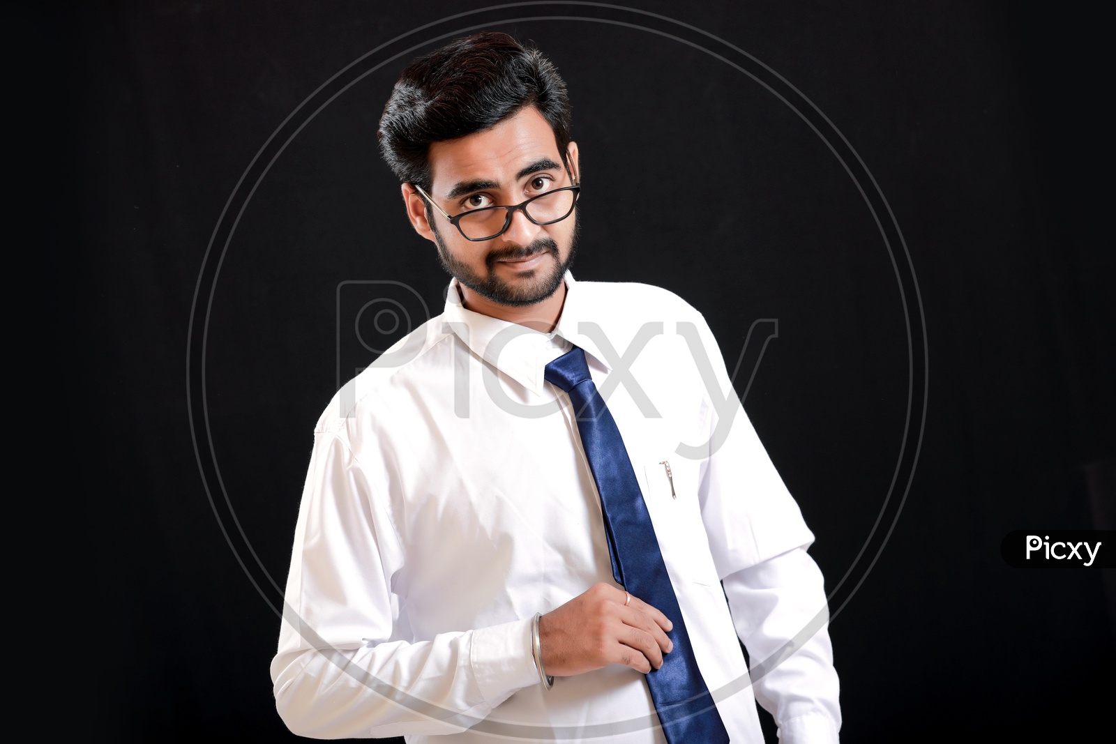 Portrait Of A Confident Young man in Formal wear looking to Camera With Black Background