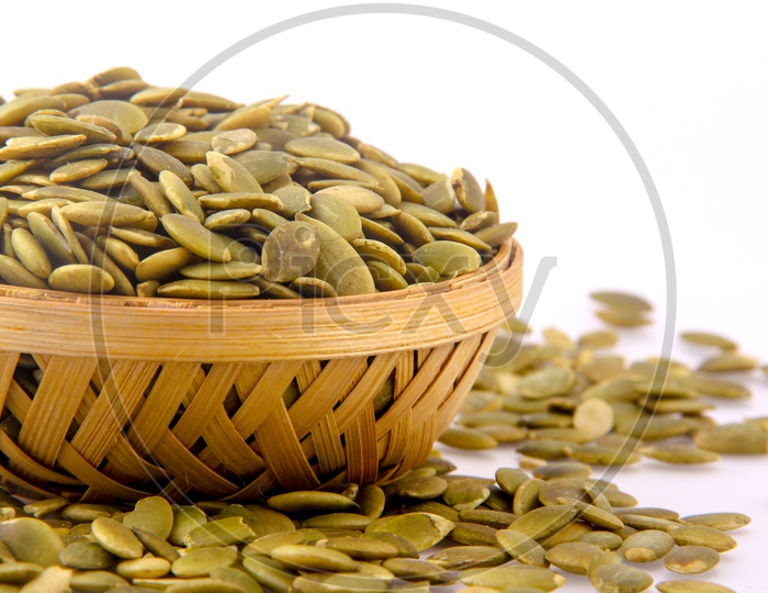 Pumkin Seeds in a Bowl On an Isolated White background
