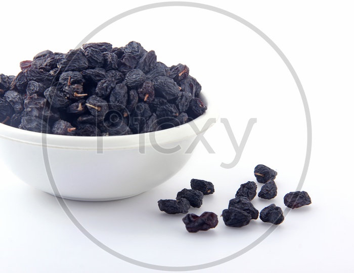 Dried fruit -  Kiss miss in a bowl  on white background - Raisins