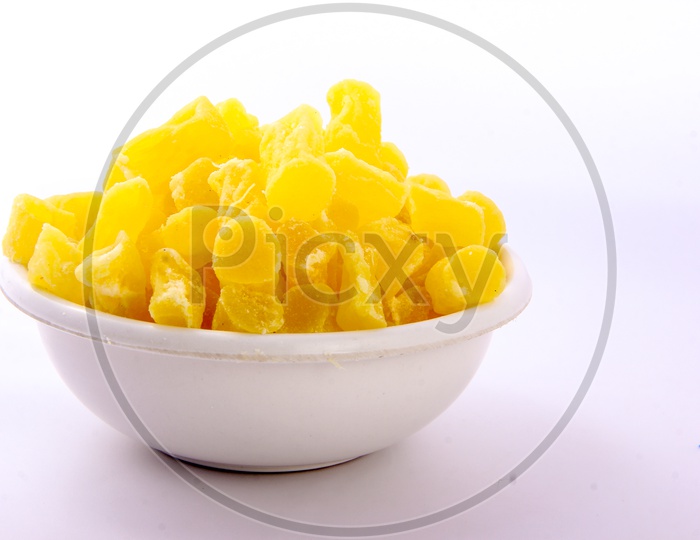 Dry Mango Pieces In a Bowl on an Isolated White Background