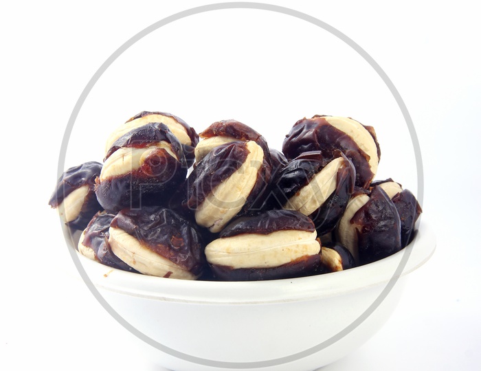 Cashew-Stuffed Dates in Bowl Isolated in White Background