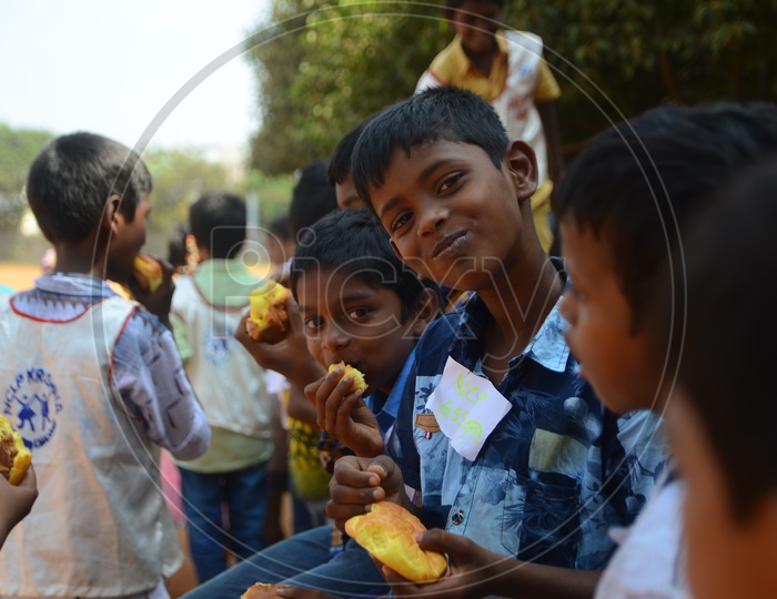 Children pose for a photograph during National Child Labour Project program