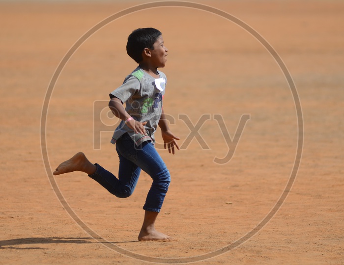 A boy runs on a play ground