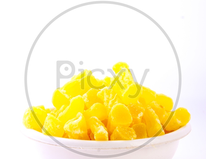 Dry Mango Pieces In a Bowl on an Isolated White Background