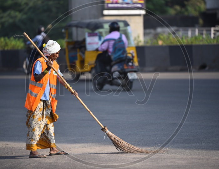 GHMC Worker Cleaning Road