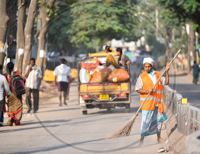 GHMC Worker Cleaning Road