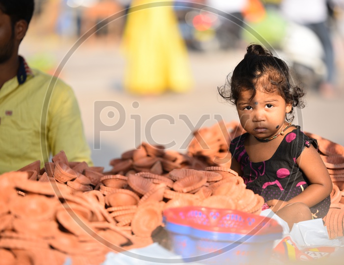 Child near Clay Lamps for Diwali