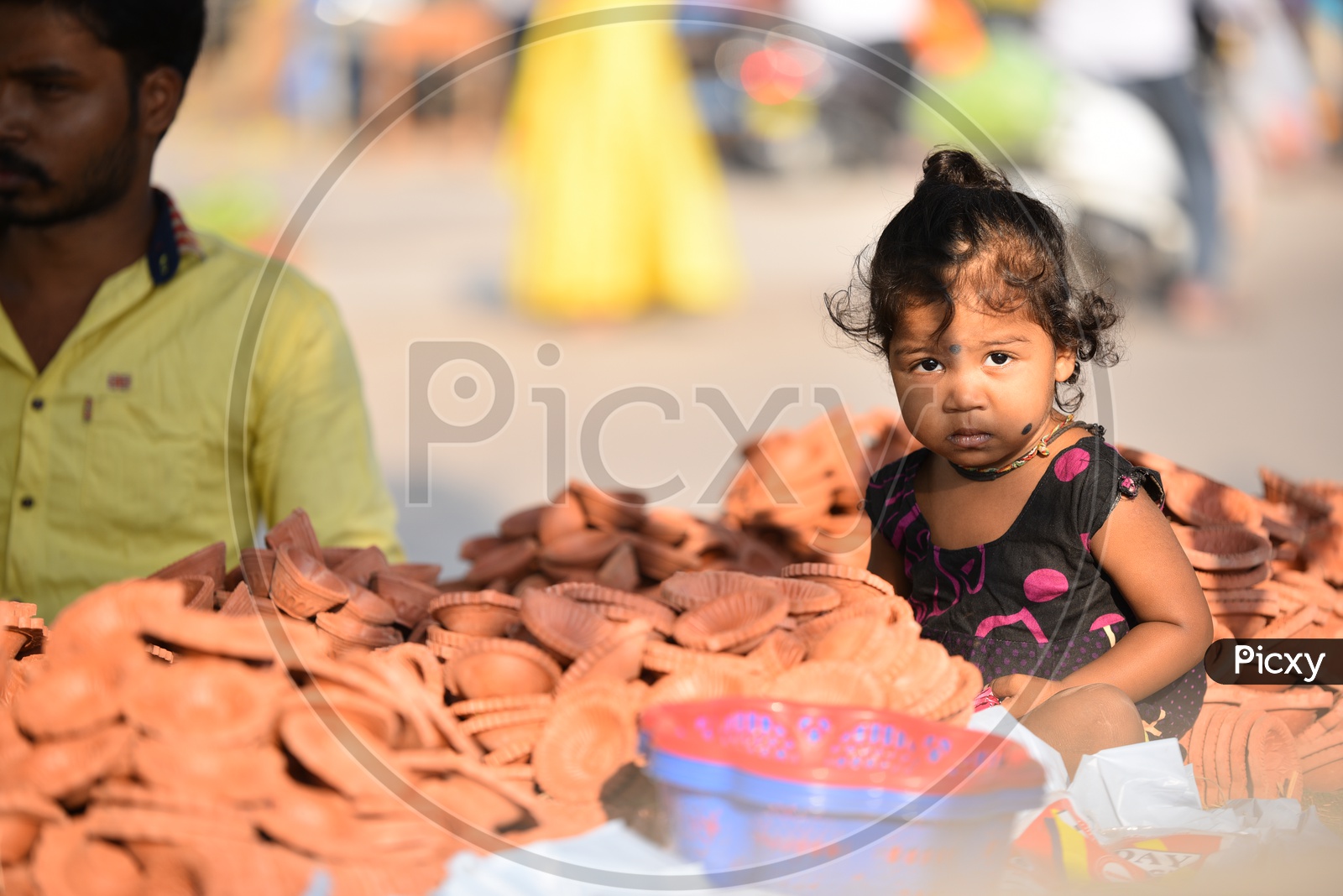 Child near Clay Lamps for Diwali