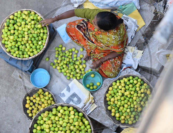 Women in Market selling Lemons