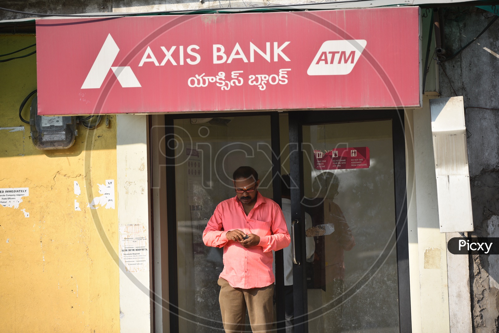 People withdrawing Cash from Axis Bank ATM