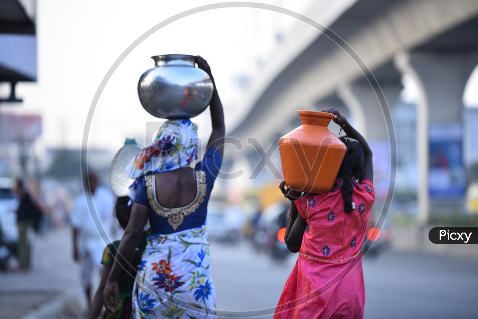 Women Walking Carrying water cans