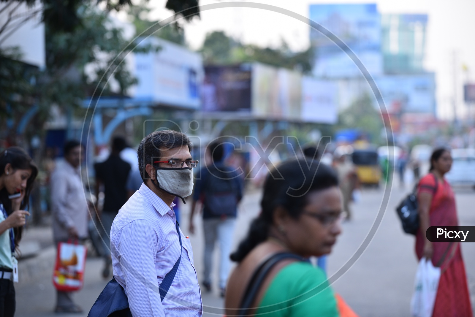 A man seen wearing anti pollution mask in a bus stop