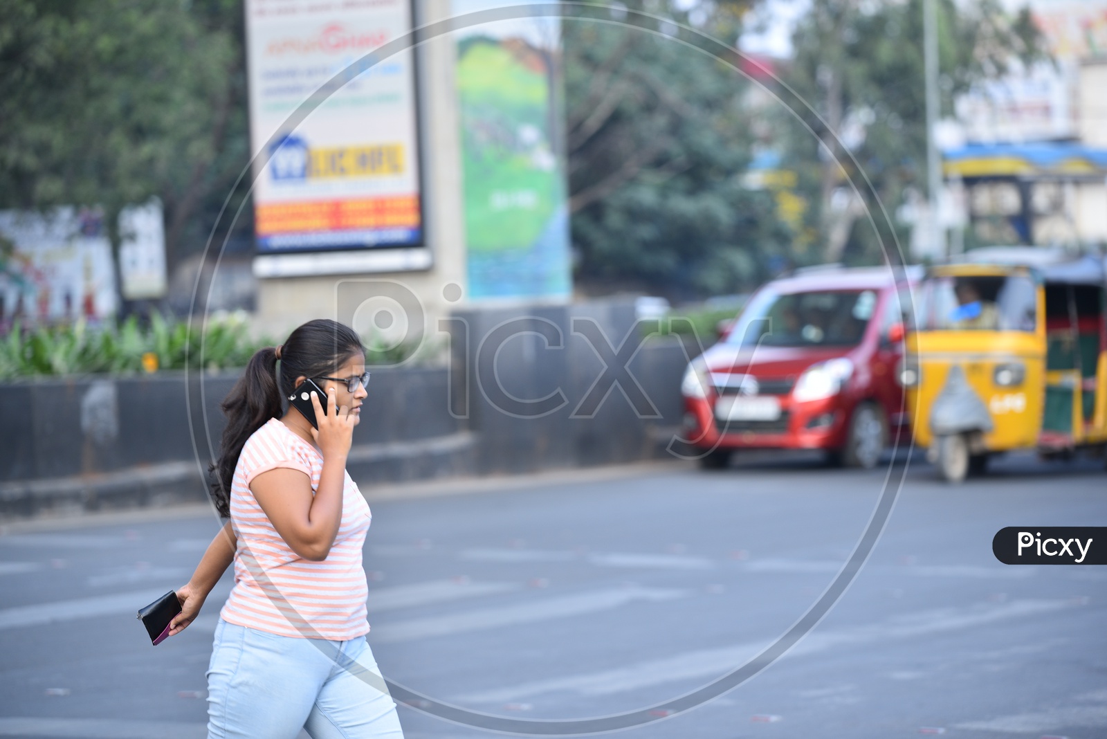 Indian Youth with Mobile Phone crossing road