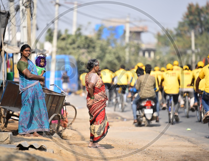 A mother, Child and Old Women Watching the CBN Army Cycle Rally in Hyderabad As A Part of Telangana General  Election Campaign 2018