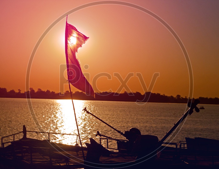 A Beautiful Sunset Over a Water body With Boat Propeller silhouette