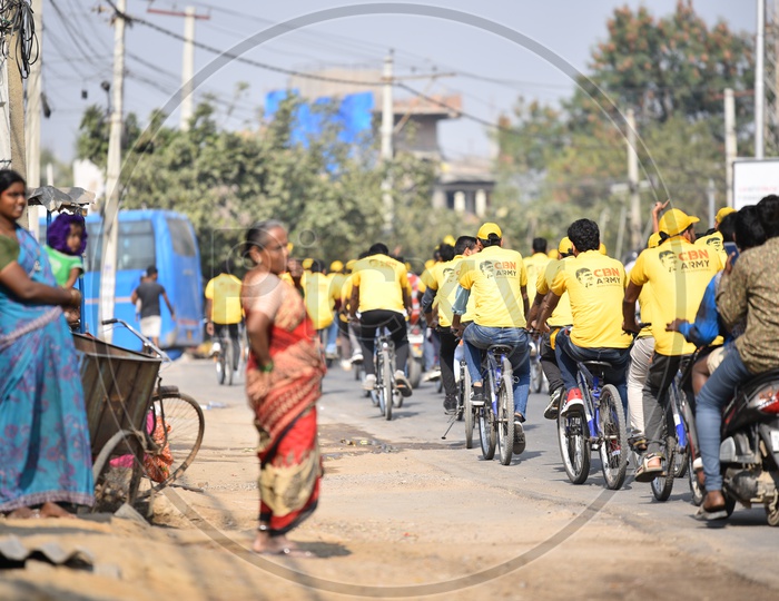 A mother, Child and Old Women Watching the CBN Army Cycle Rally in Hyderabad As A Part of Telangana General  Election Campaign 2018